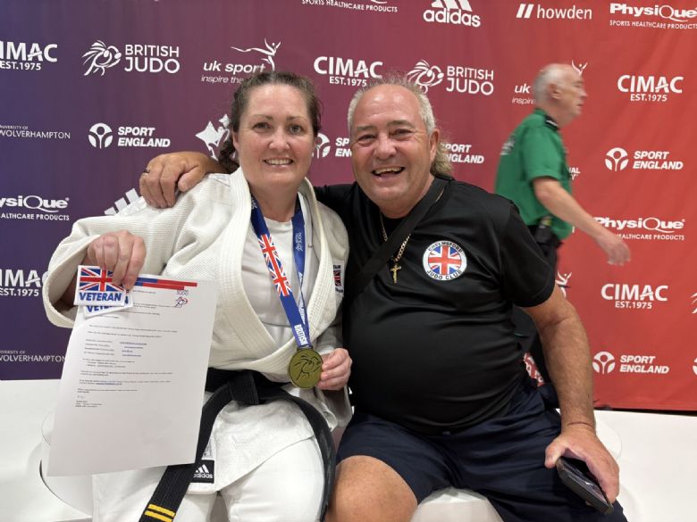 Tracey Plane with her British Judo medal and coach